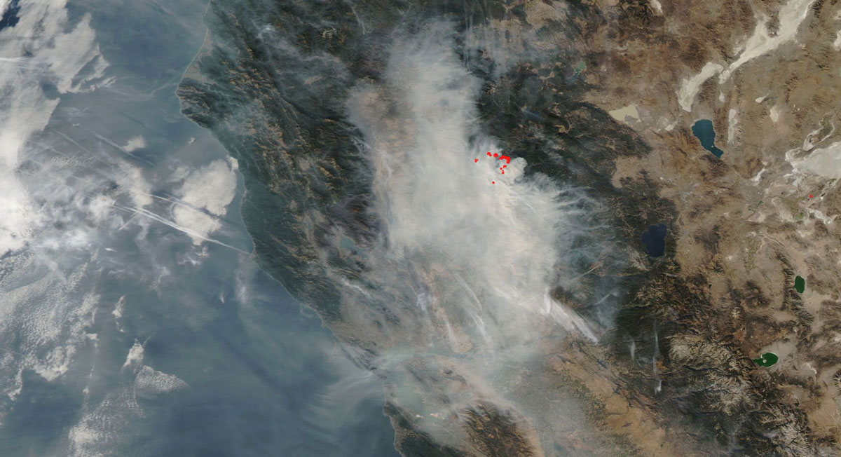 A satellite aerial view of a wildfire set by a campfire